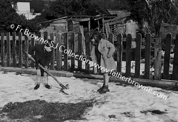 CHILD PLAYING WITH SHOVEL